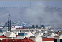  ?? — PTI ?? Smoke rises from a deadly explosion outside Kabul airport on Thursday.