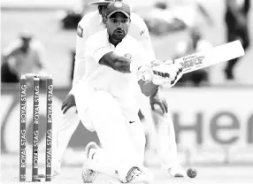  ?? - AFP photo ?? Indian batsman Shikar Dhawan plays a shot during the first day of the first Test match between Sri Lanka and India at Galle Internatio­nal Cricket Stadium in Galle on July 26, 2017.