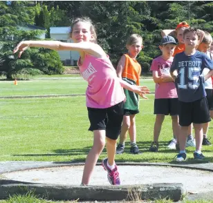  ??  ?? Tannah Orgill launches the shot put; Photograph­s: Paul Cohen.