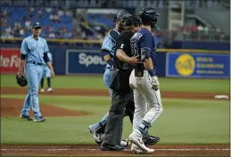  ?? CHRIS O’MEARA — THE ASSOCIATED PRESS ?? Tampa Bay Rays’ Kevin Kiermaier, right, is held back by home plate umpire Bruce Dreckman and Toronto Blue Jays catcher Danny Jansen after Kiermaier was hit with a pitch by starting pitcher Ryan Borucki, right, during the eighth inning Wednesday.