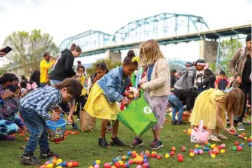  ?? STAFF PHOTO BY OLIVIA ROSS ?? Children excitedly pick up as many eggs as they can during 2022’s Easter at Coolidge.