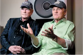  ?? CITIZEN NEWS SERVICE PHOTO ?? Beach Boys musicians Mike Love, left, and Bruce Johnston, right, speak during an interview in London. The Beach Boys have a new CD with the Royal Philharmon­ic Orchestra that gives a classical twist to their sunny 1960s hits.