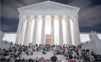  ?? TASOS KATOPODIS/GETTY 2020 ?? People mourn the death of Supreme Court Justice Ruth Bader Ginsburg in front of the Supreme Court.