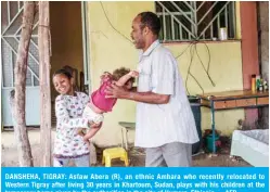  ??  ?? DANSHEHA, TIGRAY: Asfaw Abera (R), an ethnic Amhara who recently relocated to Western Tigray after living 30 years in Khartoum, Sudan, plays with his children at the temporary home given by the authoritie­s in the city of Humera, Ethiopia. —AFP