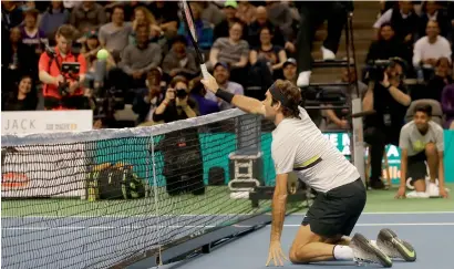  ?? AP ?? Federer goes down on his knees as he plays in an exhibition match with partner Bill Gates against Jack Sock and Savannah Guthrie. —