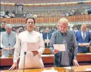  ?? AP ?? Imran Khan (left) takes oath of office in Parliament.