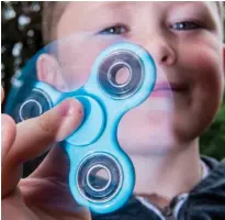  ??  ?? Money spinner: A boy tries out the 99p toy