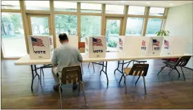  ?? AP PHOTO/ROGELIO V. SOLIS, FILE ?? A voter sits alone at a poll kiosk to cast his vote June 7at a Mississipp­i Second Congressio­nal District Primary election precinct in Jackson, Miss.