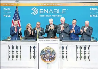  ??  ?? Rod Sailor, Enable Midstream Partners' president and CEO, center, celebrates Friday's closing of the New York Stock Exchange with, from left, Matt Beasley, assistant treasurer and senior investor relations director; Deanna Farmer, chief administra­tive officer; Mark Schroeder, general counsel and chief ethics and compliance officer; Jim Byrne, the exchange's head of U.S. listings; John Laws, Enable's chief financial officer and treasurer; and Craig Harris, chief operating officer. [PROVIDED PHOTOS]