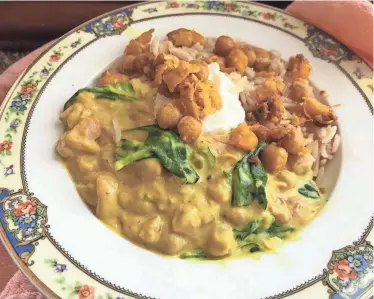  ?? RITA HEIKENFELD FOR THE CINCINNATI ENQUIRER ?? Spiced chickpea stew with coconut milk and turmeric is a perfect option for Lent. Handfuls of fresh spinach folded into the stew at the end offer color, texture and nutrition.