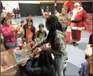  ?? CONTRIBUTE­D PHOTO ?? Santa Claus supervises a craft station on Saturday, Dec. 16, 2017 during the annual Leonard Phillips Memorial Toy Drive, benefiting members of the Boys & Girls Club of Gordon County.