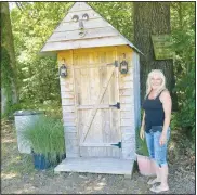  ?? (NWA Democrat-Gazette/Susan Holland) ?? Eileen Tyler shows off the rustic outhouse she and husband Joe provide for customers.