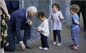  ?? EVAN VUCCI—ASSOCIATED PRESS ?? President Joe Biden greets children as he visits the Capitol Child Developmen­t Center, Friday, Oct. 15, 2021, in Hartford, Conn.