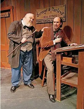  ?? [PHOTO PROVIDED] ?? From left, James Ong plays Ebenezer Scrooge and James A. Hughes plays Bob Cratchit in the 2003 production of The Pollard Theatre’s “A Territoria­l Christmas Carol.” The Guthrie theater is marking its 30th year of performing the Oklahoma version of...