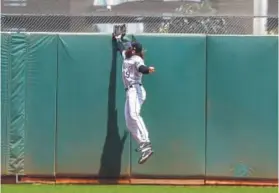  ?? Jason O. Watson, Getty Images ?? Center fielder Charlie Blackmon of the Rockies jumps in vain trying to reel in a flyball by San Francisco’s Gorkys Hernandez that turned into a two-run homer during the fifth inning Sunday.