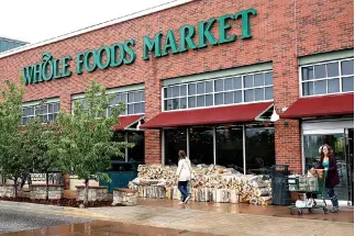  ??  ?? CUSTOMERS leave the Whole Foods Market in Boulder, Colorado, US on May 10.