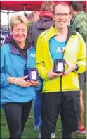  ??  ?? Gill O’Connor, left, and Paul Moses – overall winners of the Ashford Summer Series 5k