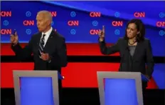  ?? Paul Sancya/Associated Press ?? Sen. Kamala Harris, D-Calif., right, and former Vice President Joe Biden participat­e in a Democratic presidenti­al primary debate July 31, 2019, at the Fox Theatre in Detroit.