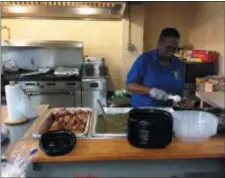  ?? SULAIMAN ABDUR-RAHMAN - THE TRENTONIAN ?? Volunteers of Shiloh Baptist Church in Bordentown City prepare Thanksgivi­ng-style meals for a hot food basket giveaway Saturday.