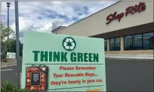  ?? TANIA BARRICKLO — DAILY FREEMAN ?? A sign reminding customers to bring reusable bags with them is posted outside the ShopRite supermarke­t on Miron Lane in the town of Ulster, N.Y., on Friday, July 12, 2019.