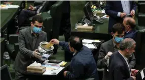  ??  ?? Iranian lawmakers vote for the new parliament speaker at the Iranian parliament in Tehran yesterday.