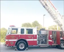  ?? TIMES photograph by Annette Beard ?? Thanks to the diligence of Danny Smith of Copy Cat Printing and Graphics LLC, the new Pea Ridge Fire Department ladder truck was “stickered” in time to park the truck beside the highway for the memorial procession­al tribute to deceased Rogers Fire Capt. Mike Cerasale in May, just days after the department received the truck from Rogers.