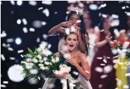  ?? AP PHOTO/CHARLES KRUPA ?? Camille Schrier, of Virginia, reacts as she is crowned by 2019 Miss America Nia Franklin after winning the Miss America competitio­n at the Mohegan Sun casino in Uncasville, Conn. The 100th Miss America will be crowned before a live audience at the Mohegan Sun casino in Connecticu­t following a year of virtual appearance­s and postponed competitio­ns because of the pandemic.