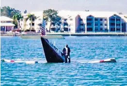  ?? XAVIER BRYAN/COURTESY ?? The pilot emerged from the plane seemingly unscathed and stood on the wing as it began to sink in an Oakland Park lake, said witness Ronald Forbes.