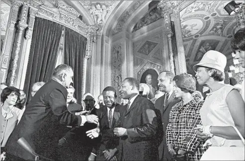  ?? YOICHI OKAMOTO/LBJ LIBRARY ?? President Lyndon B. Johnson shakes the Rev. Martin Luther King Jr.’s hand at an Aug. 6, 1965, event inWashingt­on, D.C., for the signing of the Voting Rights Act.