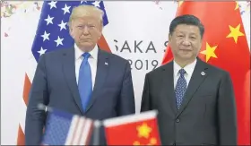  ??  ?? President Donald Trump, left, poses for a photo with Chinese President Xi Jinping during a meeting on the sidelines of the G-20 summit in Osaka, Japan.