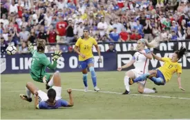  ?? — AP ?? SAN DIEGO: United States defender Julie Ertz (8) scores a goal past Brazil goalkeeper Barbara, left, as Brazil defender Adnressinh­a (17) defends during the second half of a Tournament of Nations women’s soccer match Sunday, in San Diego. The United...