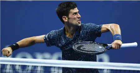  ?? — AFP ?? Novak Djokovic of Serbia celebrates after defeating John Millman of Australia in their men’s quarterfin­als at the US Open in New York.