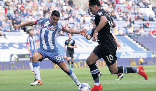  ??  ?? Ben Marshall takes the game to Wigan in the Sky Bet Championsh­ip clash; Below, Rovers boss Owen Coyle