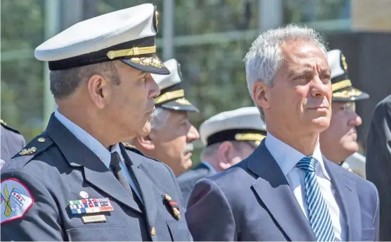  ?? ASHLEE REZIN/SUN-TIMES ?? Chicago Fire Commission­er Jose Santiago (left) and Mayor Rahm Emanuel at the funeral for Juan Bucio, a Chicago Fire Department diver who died on Memorial Day.