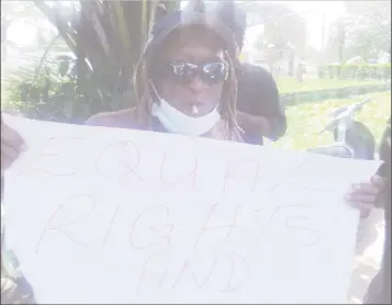  ?? ?? A member of the Rastafaria­n community smoking during the protest yesterday