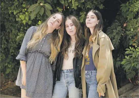  ?? Christina House For The Times ?? “IT’S HARD not to feel like we’re representi­ng California when we play other places,” says Alana Haim, center, shown with big sisters Este, left, and Danielle.