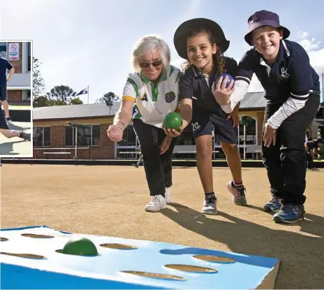  ?? Photos: Kevin Farmer ?? ON TARGET: Toowoomba Bowls Club member Christine Plater (left) teaches Toowoomba East State School students Marianna De Paula and Luke Jordan the finer points of lawn bowls. INSET: Zachary Smith sends down a shot.