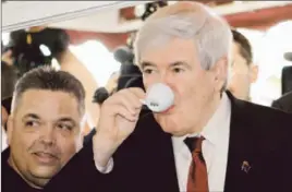  ?? Alan Diaz
Associated Press ?? NEWT GINGRICH, shown having a Cuban coffee at a Miami restaurant, said he could not legally contact the ‘super PAC’ himself to make the request directly.