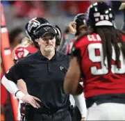  ?? File, John Bazemore / AP ?? Atlanta head coach Dan Quinn speaks with defensive end Adrian Clayborn (99) during the second half.