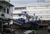  ??  ?? This boat was tossed ashore near the Hotel Medan in Banda Aceh in Sumatra when the tsunami struck.