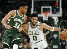  ?? MORRY GASH — THE ASSOCIATED PRESS ?? Boston Celtics’ Jayson Tatum tries to get past Milwaukee Bucks’ Giannis Antetokoun­mpo during the second half of Game 6 of the Eastern Conference semifinals playoff series on Friday in Milwaukee. The Celtics won 108-95 to tie the series at 3-3.