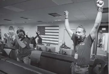  ?? BILL INGALLS NASA via AP ?? Members of NASA’s Perseveran­ce rover team rejoice in mission control at NASA’s Jet Propulsion Laboratory in Pasadena, California, after receiving confirmati­on the spacecraft successful­ly touched down on Mars on Thursday.