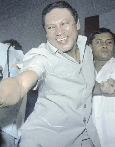  ?? CARLOS SCHIEBECK / AFP / GETTY IMAGES ?? General Manuel Antonio Noriega shakes the hands of followers in Panama City in 1988. The Panamanian strongman, who was ousted by U.S. forces in 1989, died late Monday.