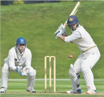  ?? Picture / ODT ?? Otago centurymak­er Anaru Kitchen hits out as Auckland wicketkeep­er Ben Horne watches.