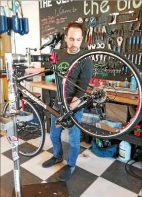  ?? JEAN BONCHAK — THE NEWS-HERALD ?? Servicing as well as selling several types of bicycles are among features offered at the Bicycle Hub in Kirtland. Shown is owner Rob Ponti working on an Orbea model.