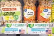  ?? MARK SCHIEFELBE­IN/ASSOCIATED PRESS ?? Nuts imported from the United States are displayed at a supermarke­t in Beijing on Friday. Many fear that possible U.S. tariffs may lead to a trade war.