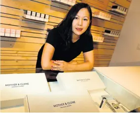  ?? AP ?? In this Friday, July 26, 2019 photo, Leslie Siu poses for a portrait next to her cannabis spray products geared toward women on display in Groundswel­l dispensary in east Denver.