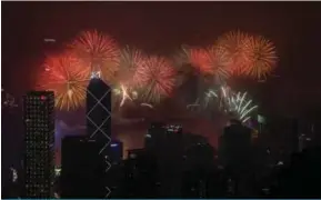  ??  ?? Fireworks explode over Victoria Harbor in Hong Kong.