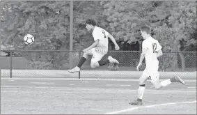  ?? Tim Godbee ?? Edward Soto and the Calhoun Yellow Jackets battle Dawson County in the first round of the state playoffs. Calhoun won the game 1-0 (4-2 in PKs).