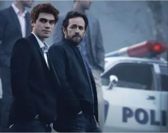  ?? DIYAH PERA THE CW ?? K.J. Apa, left, as Archie Andrews and Luke Perry as Fred in the CW's "Riverdale," which has a much darker vibe than the classic Archie comics.